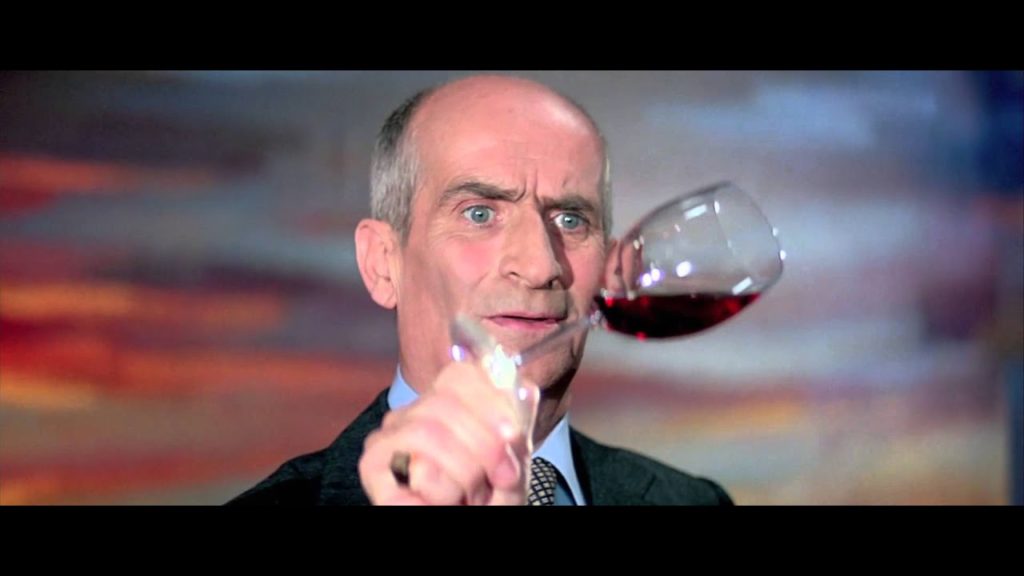 Louis De Funès un verre de vin à la main dans "L'aile ou la cuisse" de Claude ZIDI